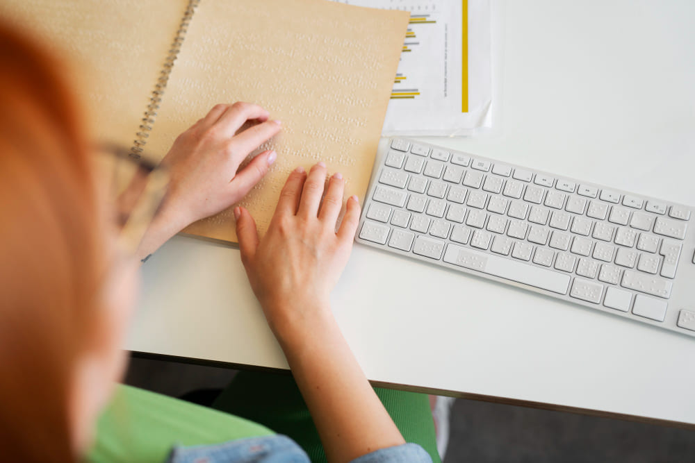 bling-woman-reading-braille-at-inclusive-office-job (1)