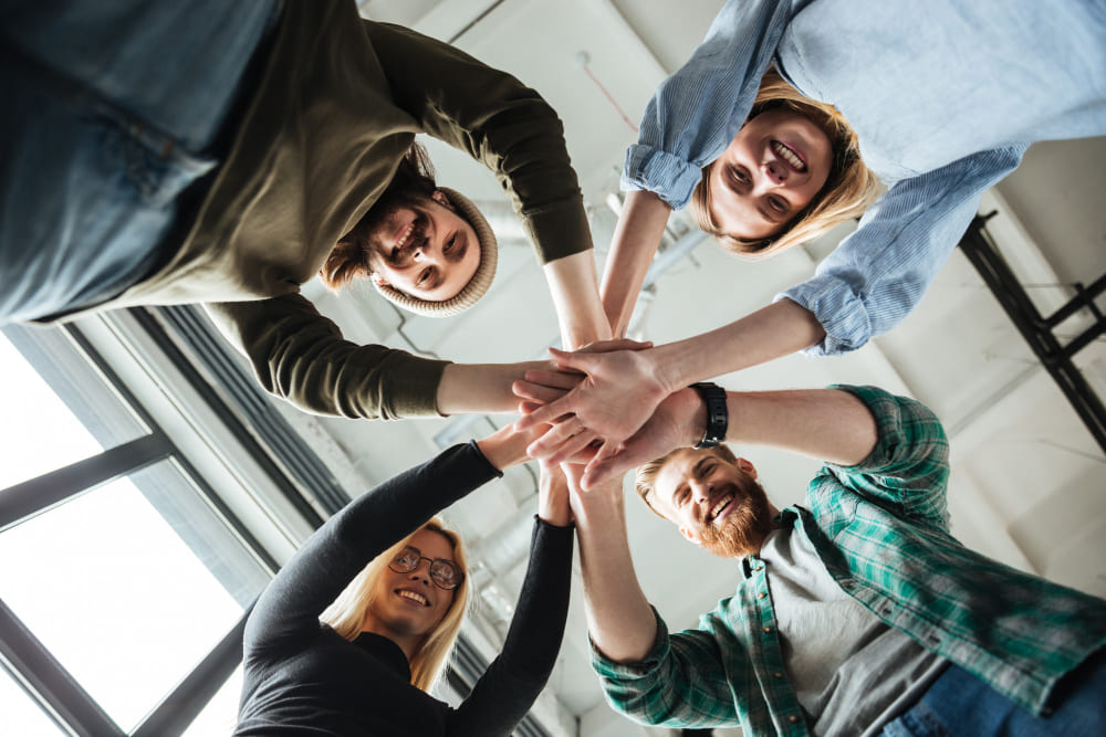 colleagues-in-office-holding-hands-of-each-other (1)