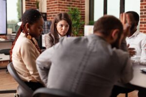 diverse-businessteam-developing-company-project-discussing-management-strategy-during-business-meeting-in-startup-office-entrepreneurs-analyzing-financial-graph-brainstorming-ideas (1)