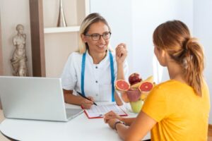 female-nutritionist-giving-consultation-to-patient-making-diet-plan-in-weight-loss-clinic (1)