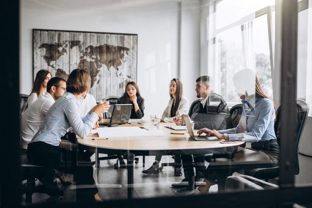 group-of-people-working-out-business-plan-in-an-office (3) (1) (1)