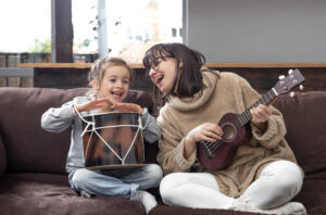 mom-plays-with-her-daughter-at-home-lessons-on-musical-instrument-children-s-development-and-family-values-the-concept-of-children-s-friendship-and-family (2)
