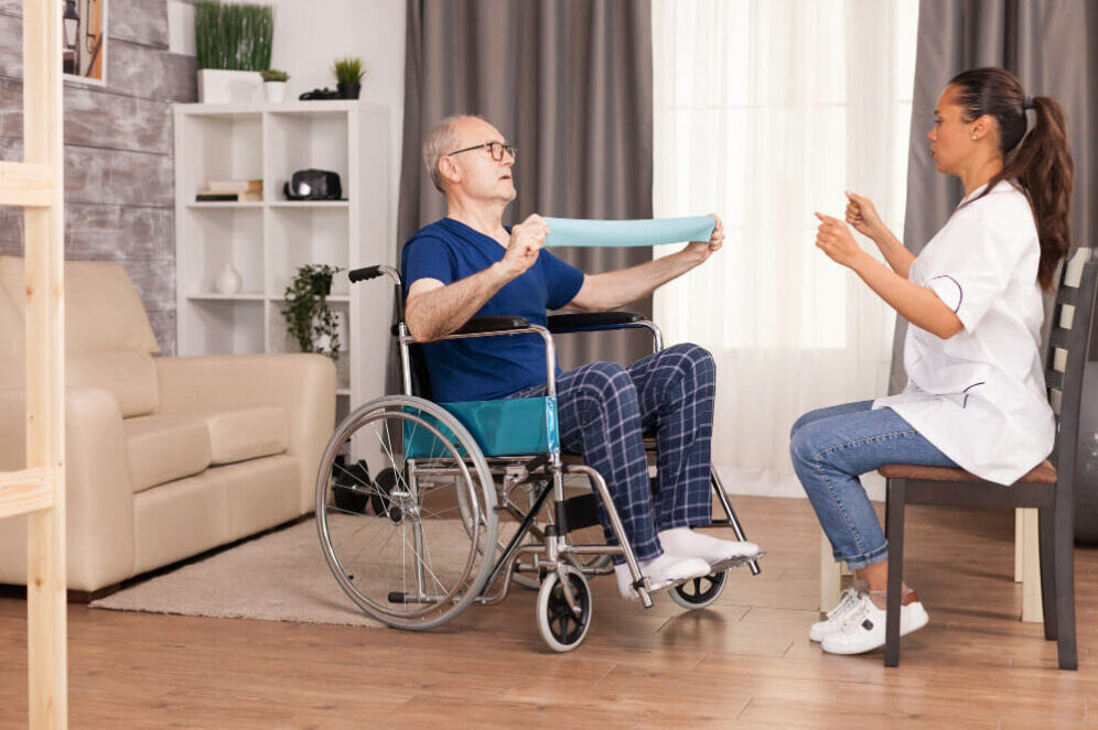 senior-man-with-disability-in-wheelchair-doing-recovery-exercise-with-resistance-band (1)