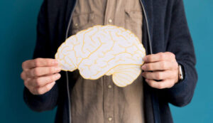 close-up-man-holding-paper-brain (1)