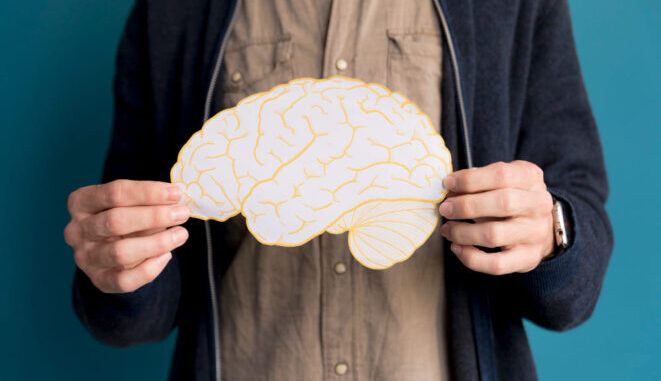 close-up-man-holding-paper-brain (1)